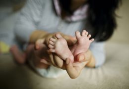 mother-holding-baby-feet-in-hand