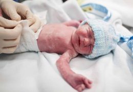newborn-baby-covered-in-vernix-getting-nappy